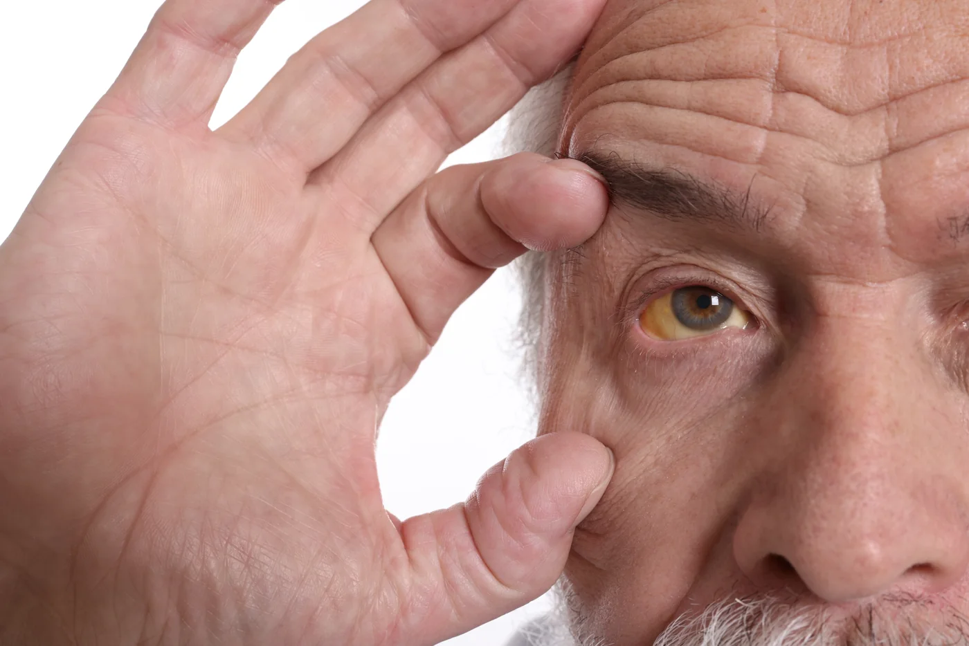 Senior man having vision test with trial lens set during eye exam.
